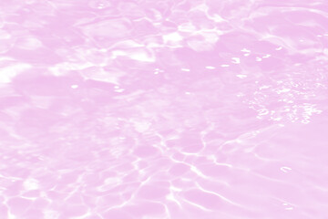 Purple water with ripples on the surface. Defocus blurred transparent pink colored clear calm water surface texture with splashes and bubbles. Water waves with shining pattern texture background.
