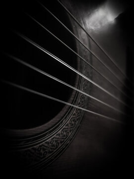 close up classical guitar on black and white (vertical image)