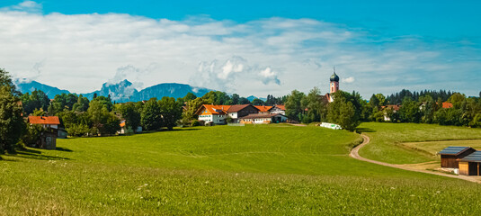 Fototapeta na wymiar Alpine summer view with a church near Seeg, Ostallgaeu, Bavaria, Germany
