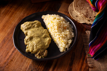 Pipian, also known as mole verde, food from mexico and other latin american countries, chicken meat bathed in mole sauce made with pumpkin seeds, dried chili peppers and several other ingredients.