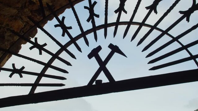 Close up shot of Hammer and pick mining symbol at mine entrance in Buggerru