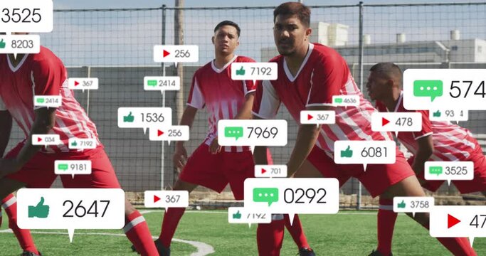 Animation of social media icons over team of diverse male soccer players stretching on sports field - Powered by Adobe