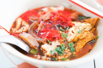 Selective focus Yong tau foo Tom Yum noodles, Spicy noodles in the Tom Yum soup