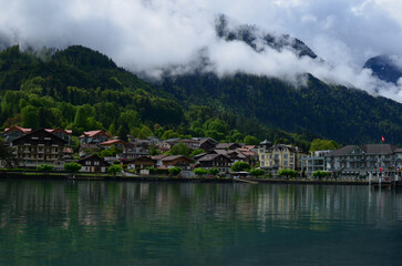 Fototapeta na wymiar Picturesque view of beautiful village on lake shore near mountains