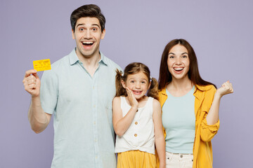 Young parents mom dad with child kid daughter girl 6 year old wear blue yellow casual clothes hold...