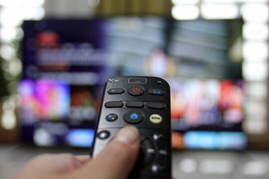 Cord Cutters Watching tv and using remote control