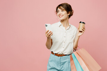 Young woman wear casual clothes hold shopping paper package bags, takeaway delivery cup coffee to...