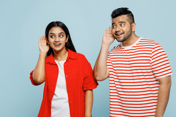 Young curious couple two friends family Indian man woman wear red casual clothes t-shirt together...