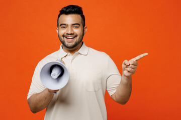 Young Indian man he wearing white t-shirt casual clothes hold in hand megaphone scream announces...