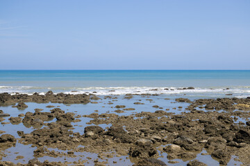 Sea rock reef with blue sky