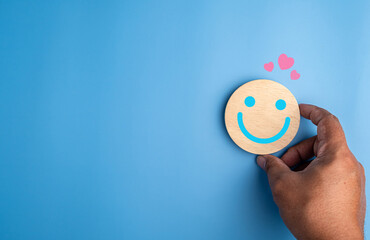 emoticon smiley face wooden round pink heart blue background service rating feedback interesting satisfaction concept