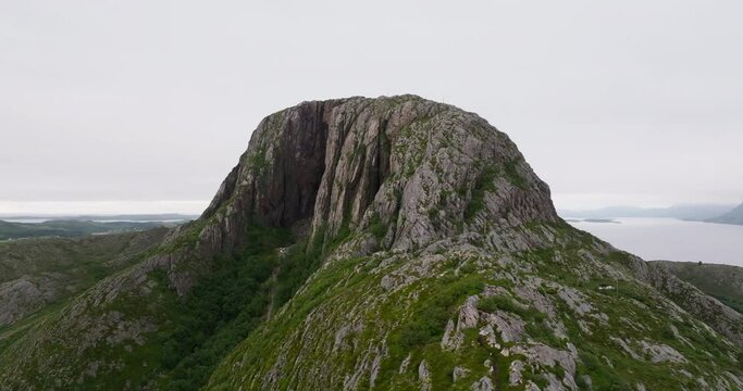 Drone orbit mystical Torghatten with famous dark erosion hole through mountain