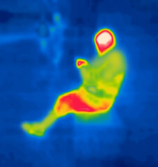 Man sitting. Image from thermal imager device. Modified unrecognizable people