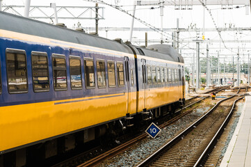Blue and yellow train leaving Utrecht Centraal Station