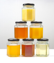Hexagonal jars with different types and colors of fresh flower honey. vitamin food for health and life