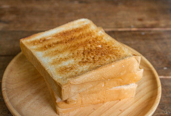 grilled fresh bread on wooden dish