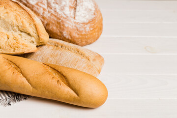 Homemade natural breads. Different kinds of fresh bread as background, perspective view with copy space
