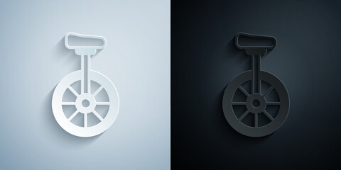 Paper cut Unicycle or one wheel bicycle icon isolated on grey and black background. Monowheel bicycle. Paper art style. Vector © Iryna