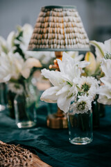 Table setting with flowers in vases and  lamp