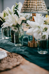 table setting with flowers in the glass vases