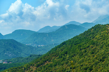 beautiful mountains, summer landscape, clouds, forest on the hillsides