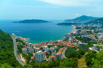 aerial view of the city on the seashore and mountains, panorama of the resorts of Becici and Budva in Montenegro, Adriatic sea, beaches, islands, tourism and travel, summer traveling