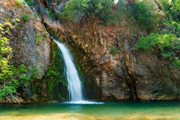 Fototapeta na wymiar waterfall in the mountains, beautiful summer bright landscape