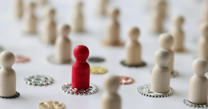 Wooden figures of people with metal gears closeup. Recruitment and team logical connection