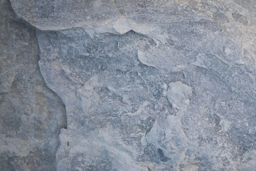 Gray rocky surface, background, abstract stone pattern with cracks