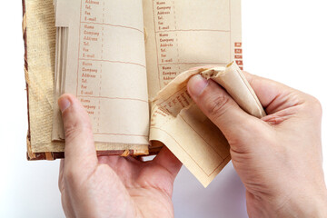 Hands of  man tearing page out of notebook close-up.. - obrazy, fototapety, plakaty