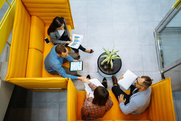 Young group of people working together in modern office discussing work issues together. Business...