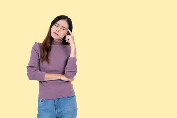 A thoughtful woman, thinking ideas or planning something in her head, isolated yellow background