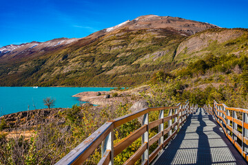 Panoramic over Lago Argentino and walking path, near Perito Moreno glacier in Patagonia with blue sky and turquoise water, South America, Argentina, in Autumn colors