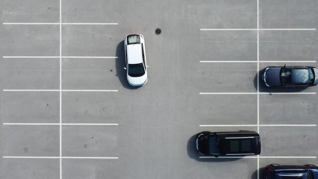 Top down video car reversing in a parking place