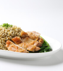 wok garlic olive fried egg rice with grilled chicken chop cutlet in brown sauce and vegetables in plate on vintage table cloth white background asian chef cuisine halal food menu for cafe