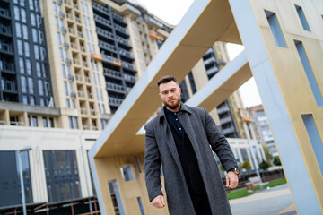 Man standing in front of a towering skyscraper