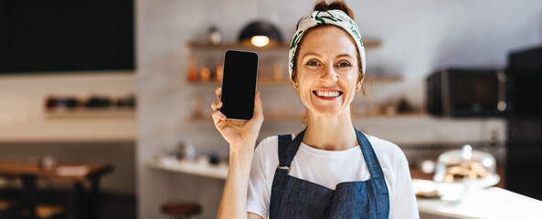 Successful small business owner recommending a smartphone for restaurant management