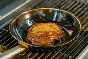 Sizzling steak cooking on a hot grill