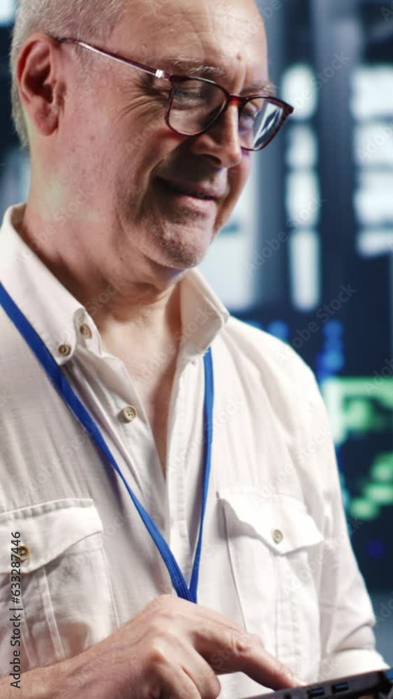 Aufkleber vertical video elderly professional navigating network of server gadgets in industrial hub. technica