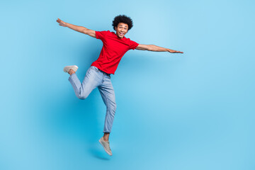 Full body photo of jumping flying wings hands youngster guy feel free summer holidays no university isolated on blue color background