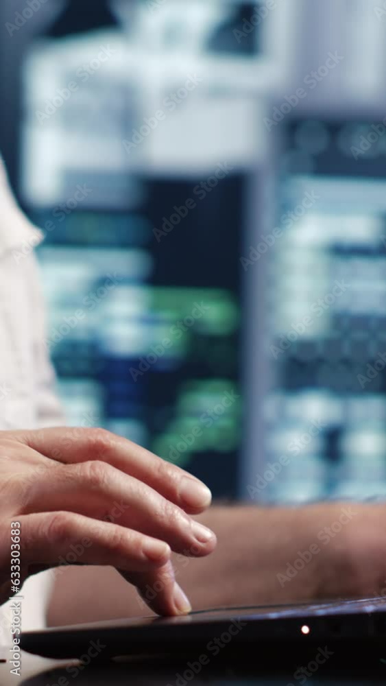 Aufkleber vertical video certified it admin expertly managing data while navigating in industrial server room.