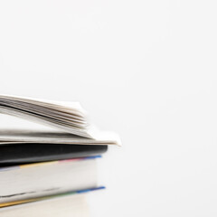 Books collection in pile and one of them open on top. Education concept.