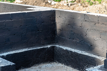 Footings made of concrete blocks painted with black dispersion asphalt-rubber mass, reinforced...