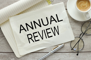 ANNUAL REVIEW the torn page lies on the notebook. words