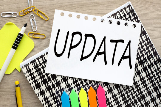 update top view of torn page on notepad on wooden table.word on page