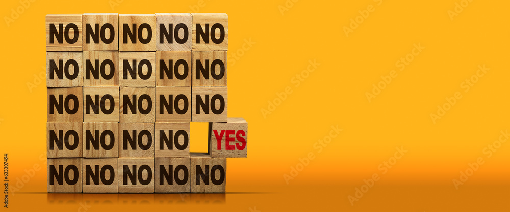 Poster stack of wooden blocks with text yes or no. on a yellow and orange background with copy space and re