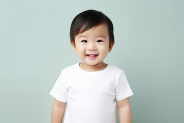 design mockup: Asian baby studio portrait in a white t-shirt on a neutral background