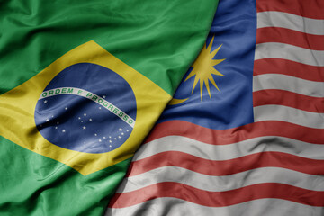 big waving realistic national colorful flag of brazil and national flag of malaysia .