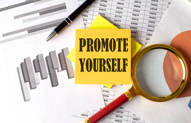 PROMOTE YOURSELF text on a sticky on the graph background with pen and magnifier