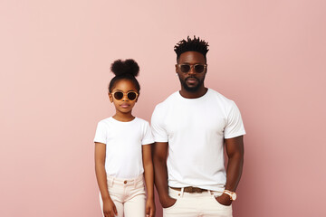 design mockup: black father and daughter wearing white t-shirts studio shot on neutral background - Powered by Adobe
